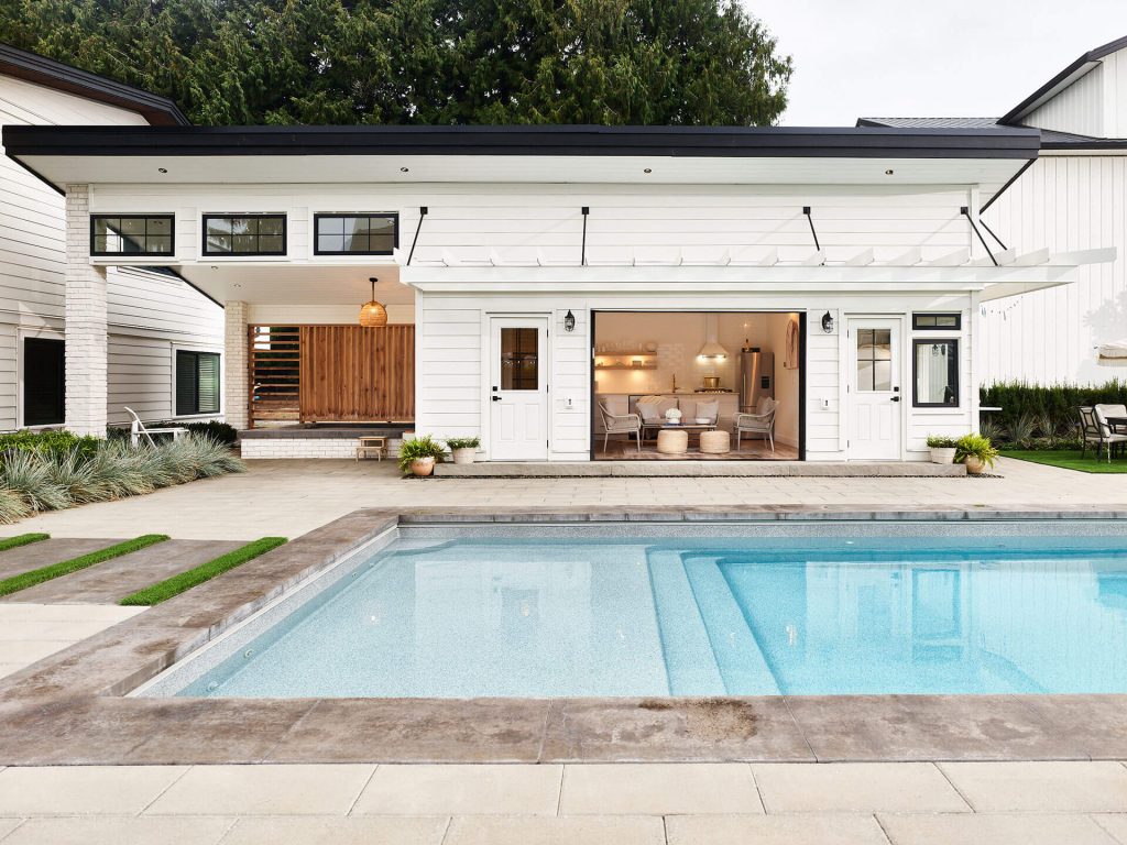 Shallow-end pool entry steps with modern tile and clean pool deck design.