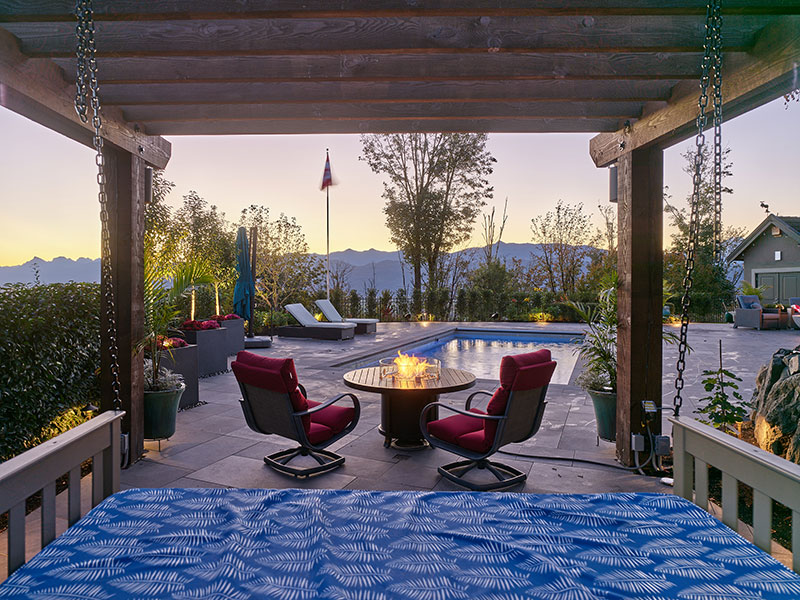 Outdoor living space overlooking a custom pool and mountain views at sunset, representing the Dream phase of Rockwest Creative’s design process.