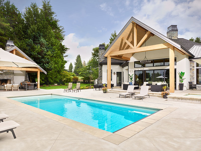 Sunken outdoor living area with built-in seating, modern fire feature, and integrated entertaining space designed by Rockwest Creative.